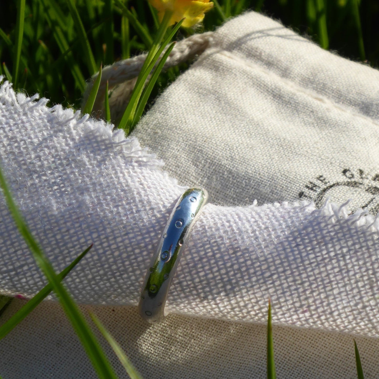 Solid 925 Sterling Silver D-shaped band with a hand-stamped polka dot repeat pattern and a high shine finish. Perfect as a standalone statement ring.